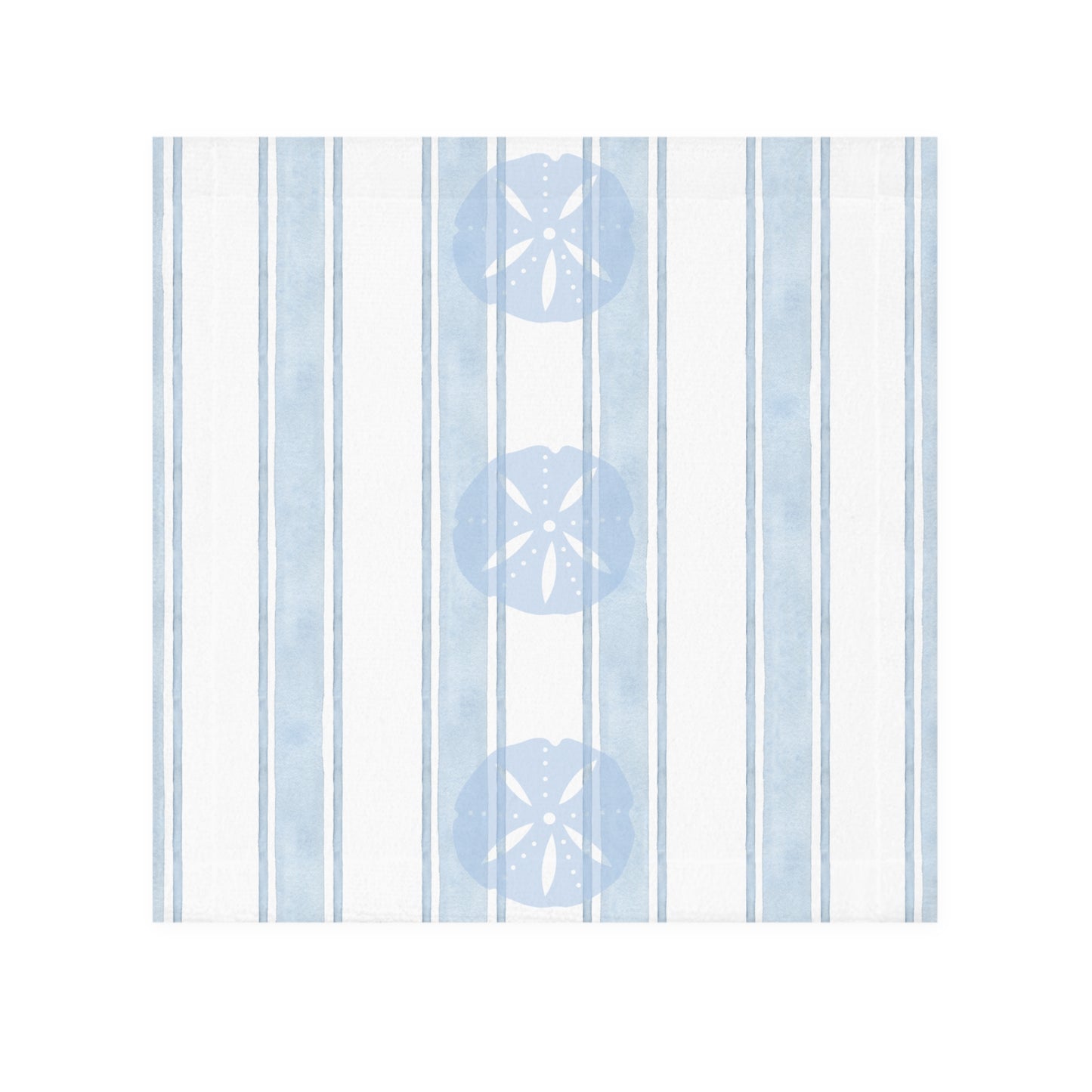 Beach-inspired bathroom decor featuring a sand dollar patterned towel hanging against a soft coastal wall.