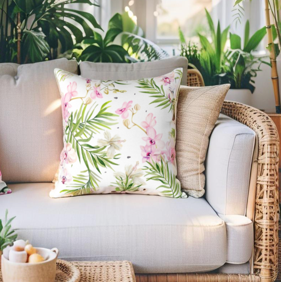 Botanical-inspired tropical pillow with pink and green floral print.