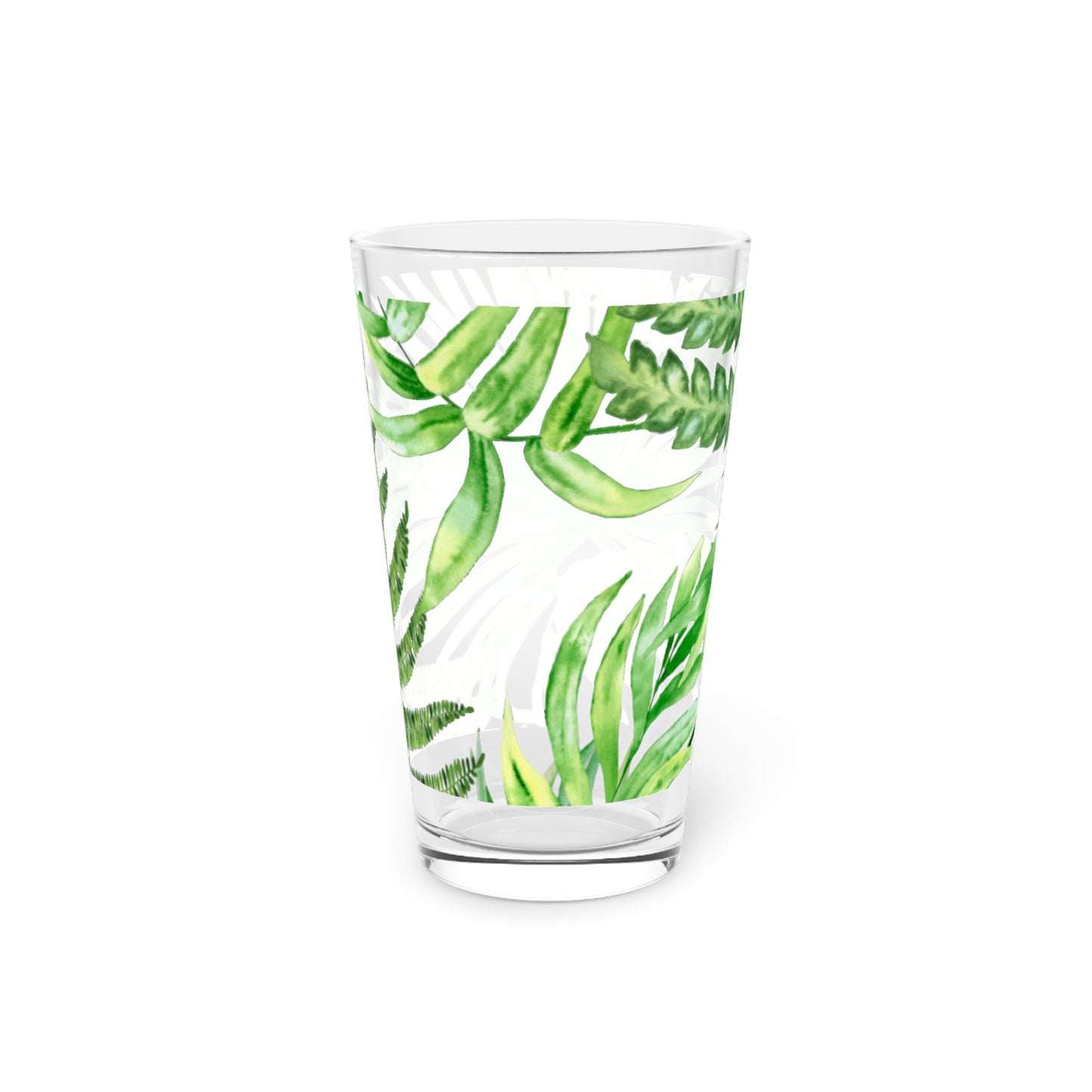 Coastal-style pint glass with tropical leaves, perfect for ocean-themed kitchens.