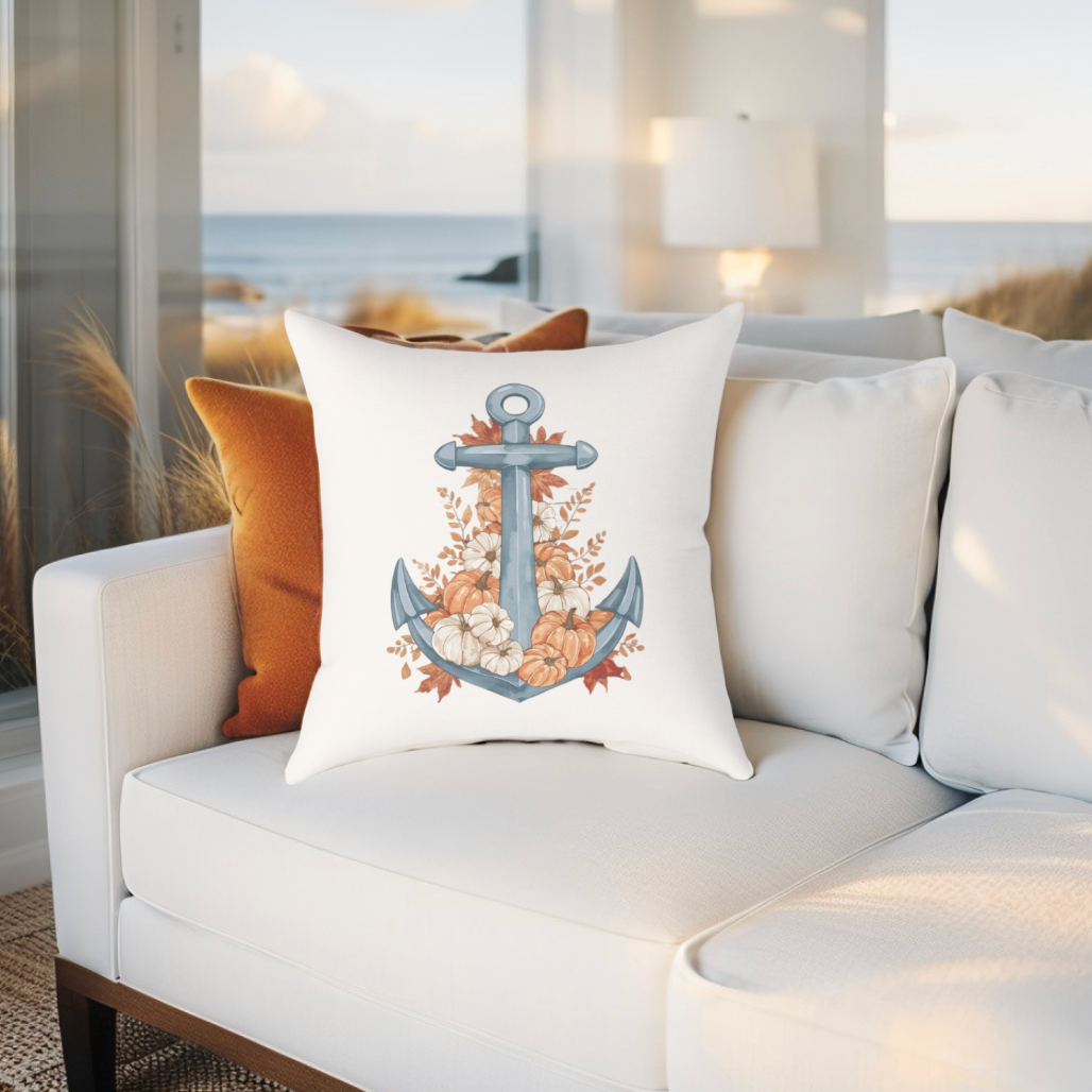 Decorative pillow with an anchor design on a white couch in a living room setting.