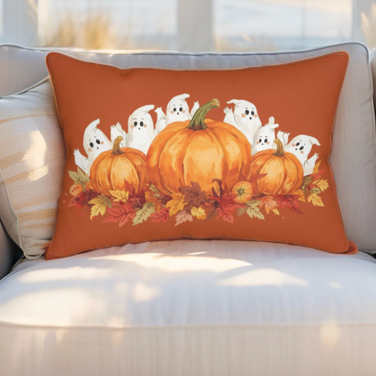Decorative pillow with pumpkins and ghosts on an orange background