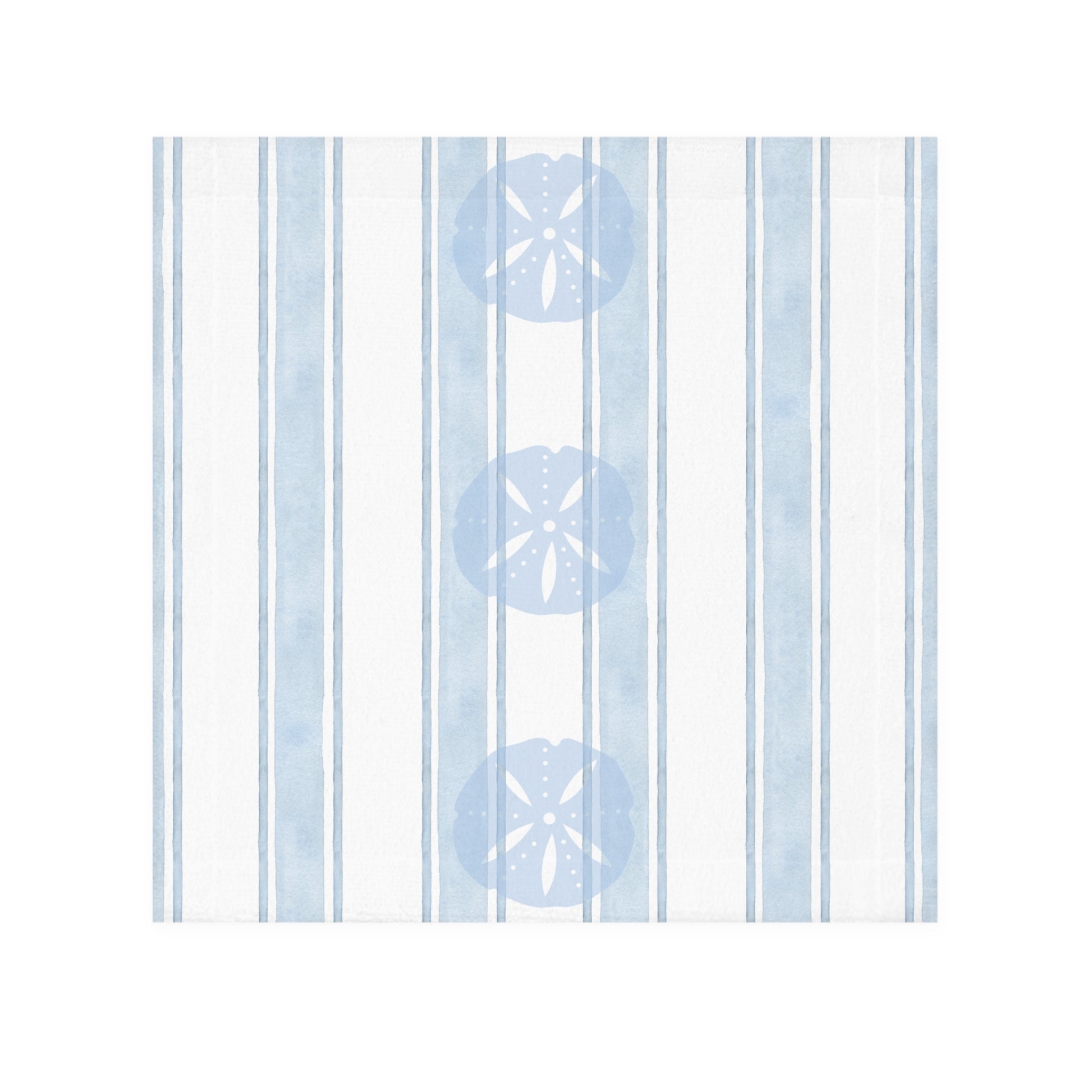 Beach-inspired bathroom decor featuring a sand dollar patterned towel hanging against a soft coastal wall.