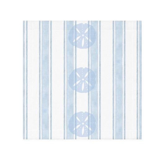 Beach-inspired bathroom decor featuring a sand dollar patterned towel hanging against a soft coastal wall.