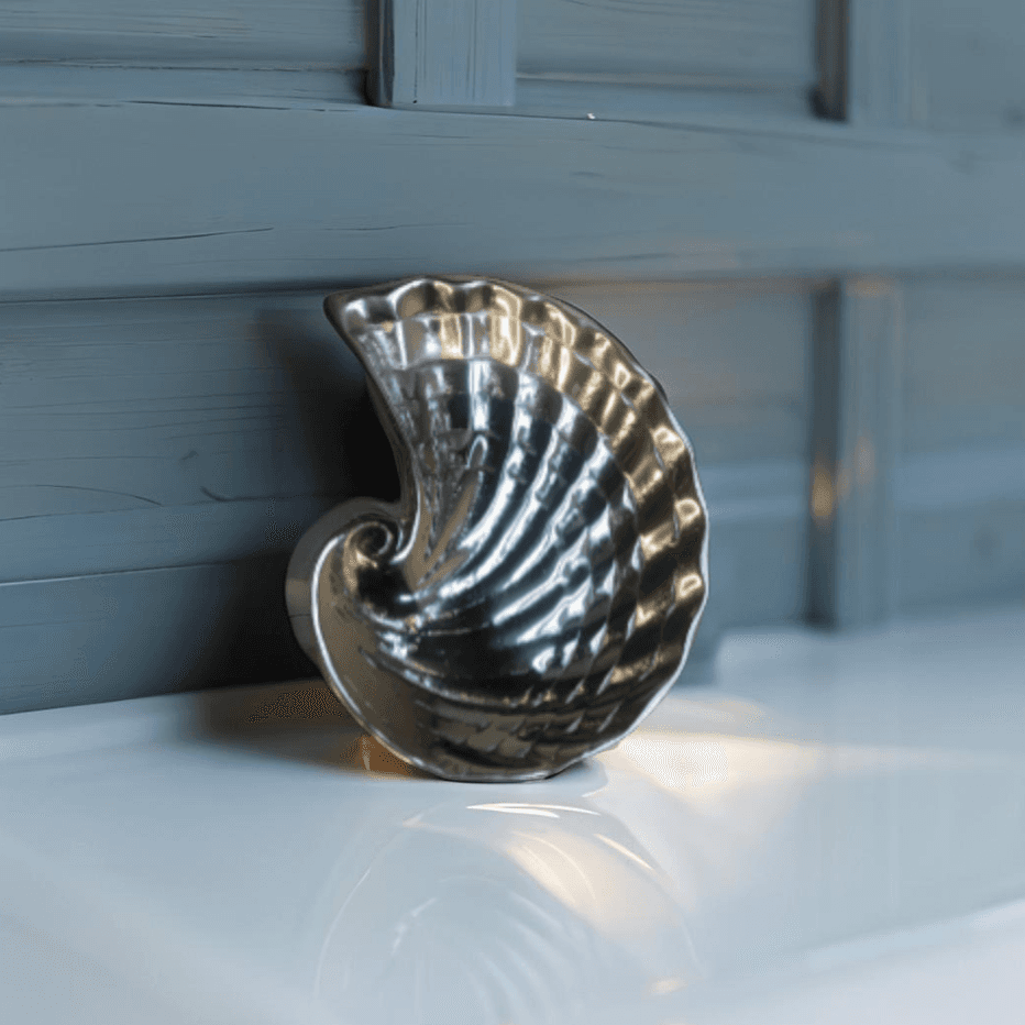 Beach-themed ceramic shell soap holder on a vanity counter