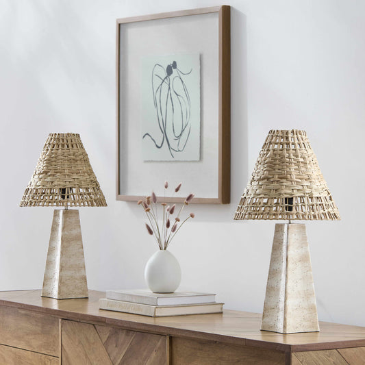 Pair of coastal rattan table lamps with natural woven shades on a wooden console table.