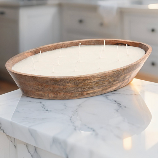 Large oval candle with wooden rim on a marble surface