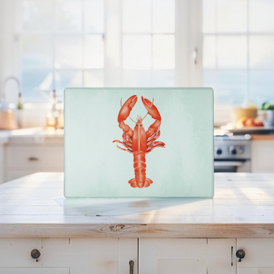 Glass cutting board with red lobster design in coastal kitchen