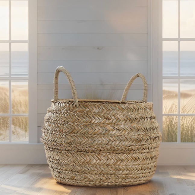 Handcrafted rattan basket styled in a bright, airy coastal home.