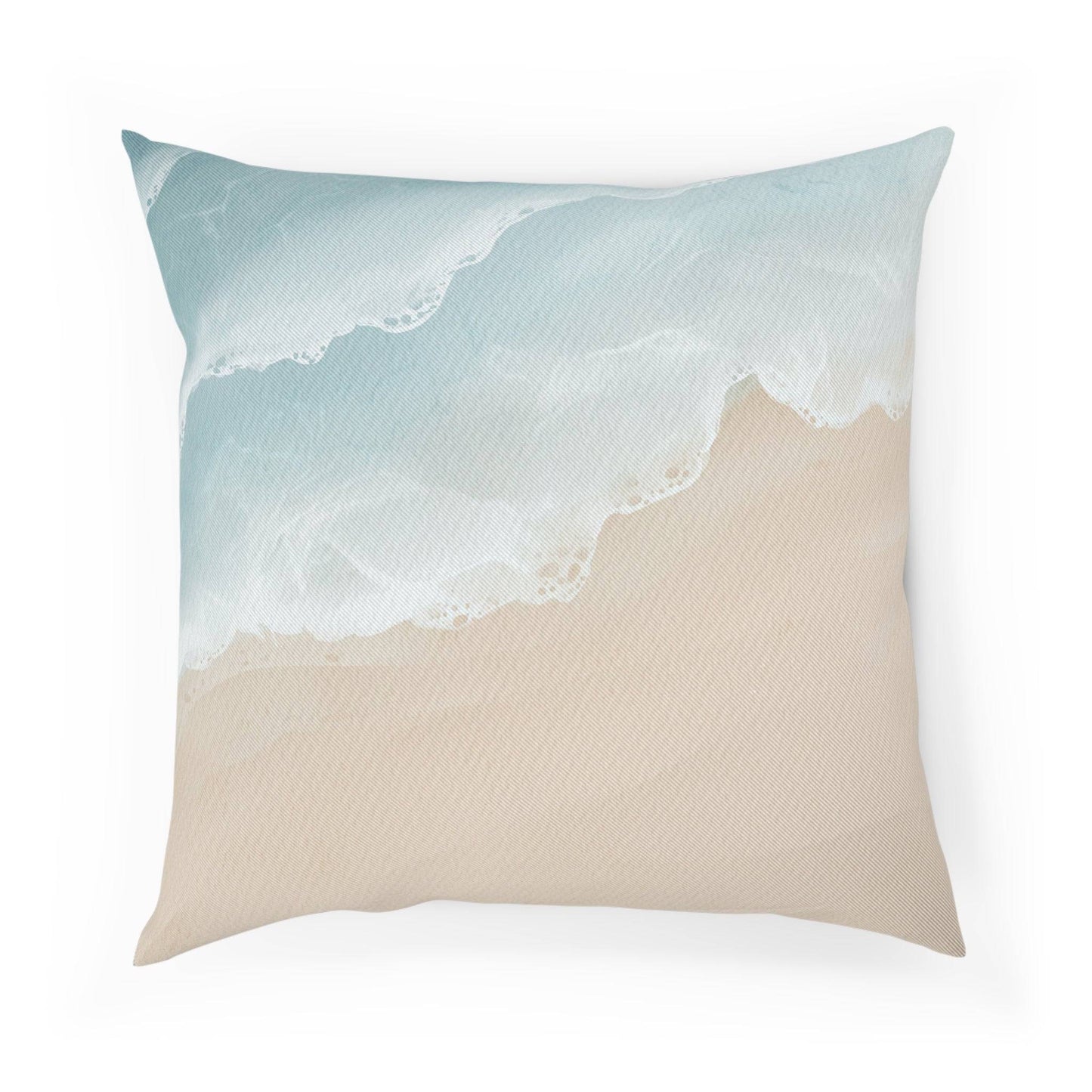 Decorative throw pillow with soft blue waves and sandy tones, styled for coastal home accents and airy interiors.
