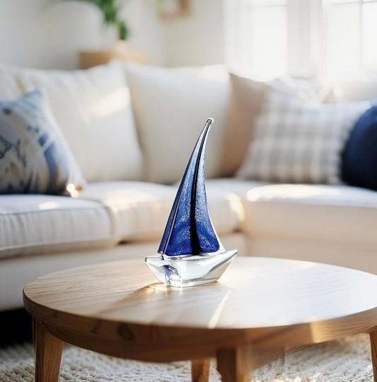 Nautical-themed glass sailboat sculpture styled on a modern shelf