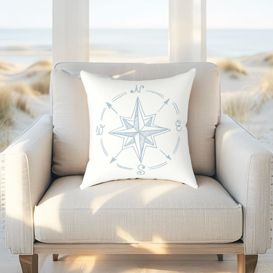 Nautical throw pillow with light blue compass print, great for seaside or ocean-inspired rooms.