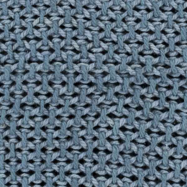 Nautical navy blanket styled in a coastal living room