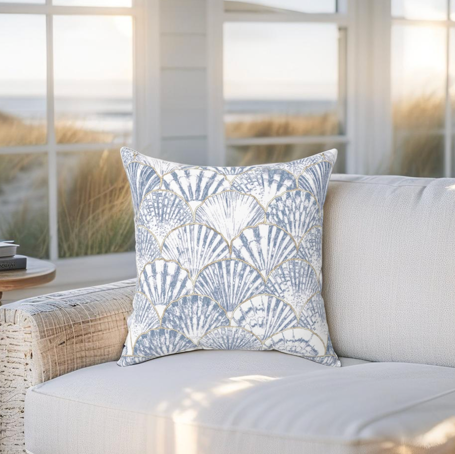 Blue and white throw pillow featuring a seashell pattern, perfect for coastal and beach-themed decor.
