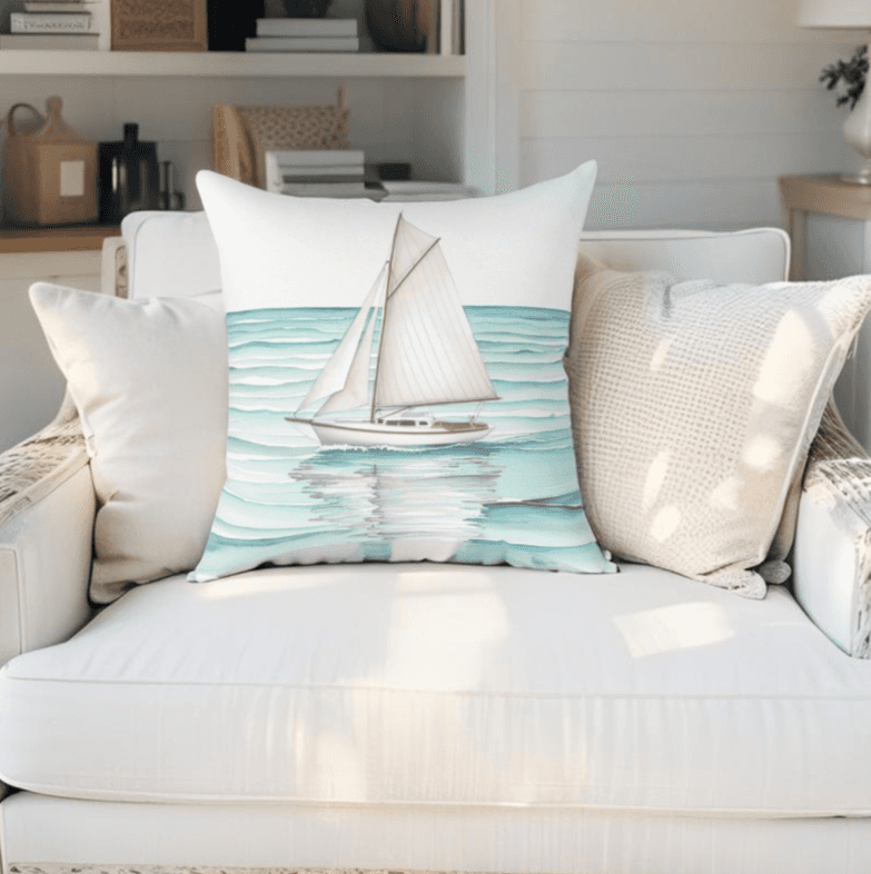 Minimalist nautical throw pillow featuring a sailboat design, styled for beach house decor.