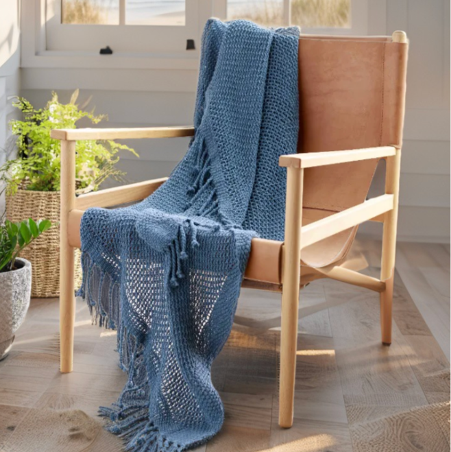 Nautical navy blanket styled in a coastal living room