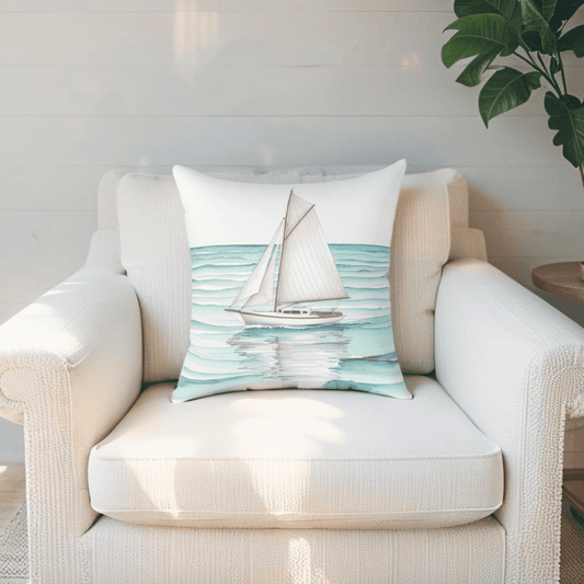 Watercolor sailboat decorative pillow on a white couch in a coastal Maine living room