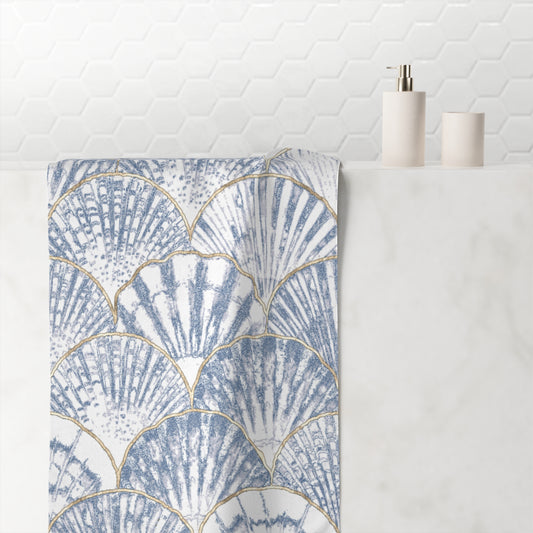 Soft blue bath towel with delicate seashell prints, perfect for a relaxing coastal feel