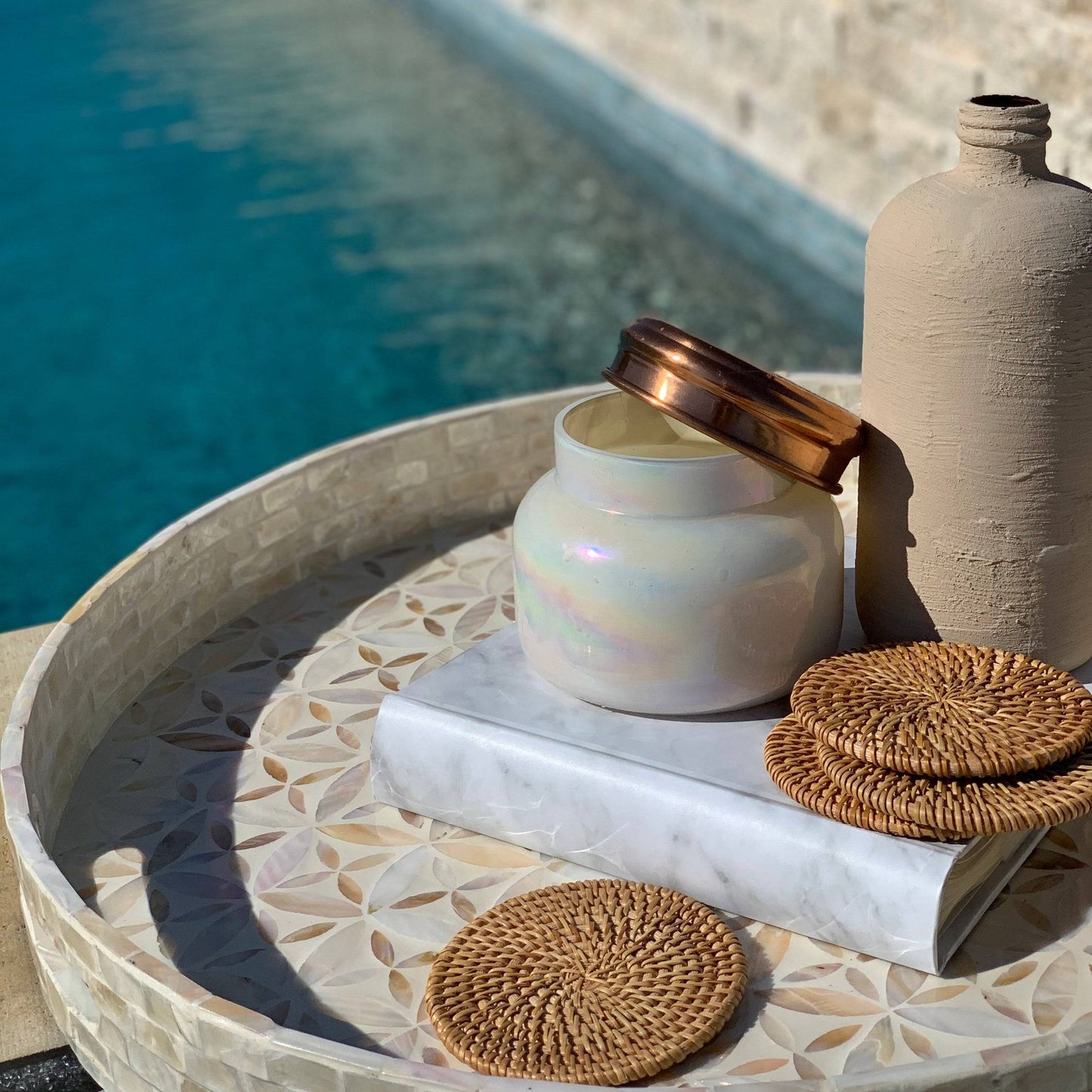 Handwoven rattan coasters on a wooden coastal table